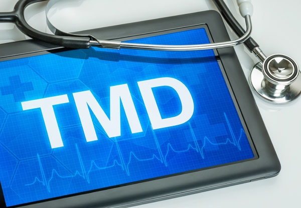 digital pad with word TMD on screen